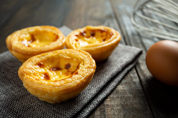 Egg tart on wooden background.