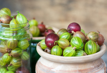 Fresh gooseberries in original bowls on wooden