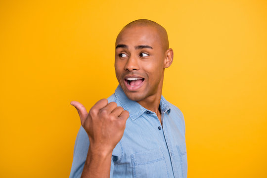 Close up photo shot picture portrait of satisfied surprised excited guy making choice pointing to the left from his shoulder isolated vivid background