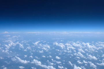 Naklejka na ściany i meble Blue sky with clouds view from the airplane porthole