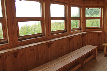 The Inside of a Wooden Lakeside Bird Watching Hide.