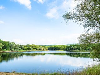 karst lake in forest in sunny summer day