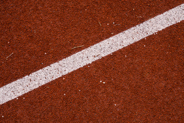 Surface of rubber pellets in treadmill athletics field texture background.
