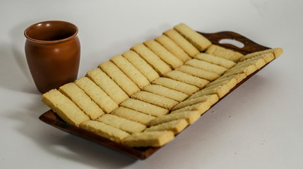 cup of tea and cookies on wooden table
