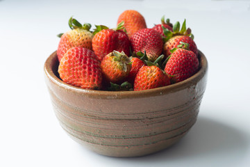 strawberries in a bowl with white background 