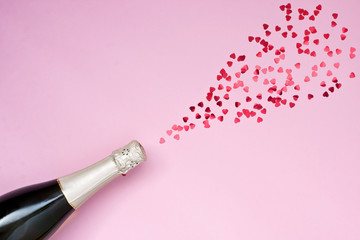 Champagne bottle with colorful party confetti