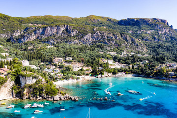 Fototapeta premium Aerial view of beautiful green and rocky island in the blue ocean.