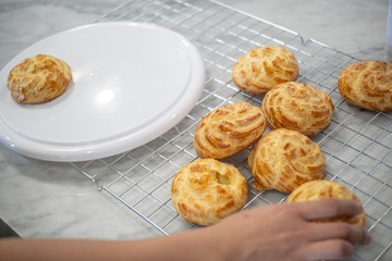 Women hand holding Choux Cream put on a display.