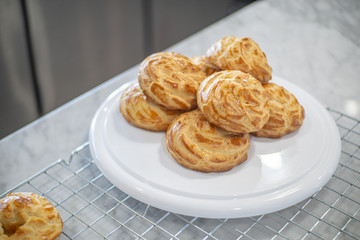 Side view of Choux Cream on a rack.