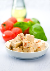Cheese cubes with tomato and basil 