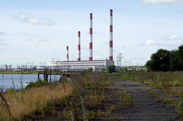 Power station on the river bank on a sunny day