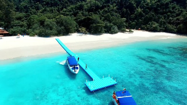 aerial view of tourist speed boat approach on floating pige