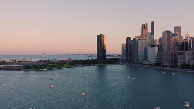 Low angle aerial above Lake Michigan looking towards Chicago Downtown