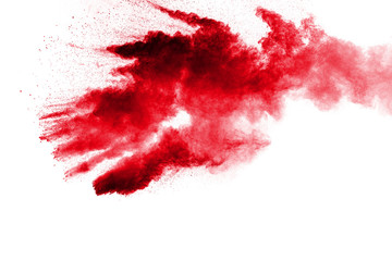 Abstract red dust splattered on white background. Red powder explosion.Freeze motion of red particles splashing.