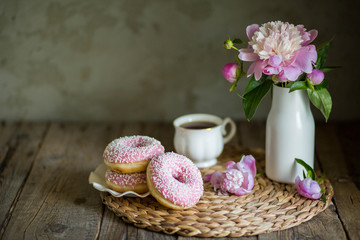 Obraz na płótnie Canvas Donuts with fragrant tea. Bakery products. Peonies