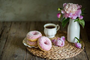 Obraz na płótnie Canvas Donuts with fragrant tea. Bakery products. Peonies