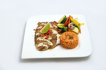A Hero shot of a grilled fish fillet gratini with vegetables & lentils on the side, on a white plate, minimal background with a 60 degree front facing perspective.