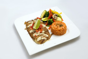 A Hero shot of a grilled fish fillet gratini with vegetables & lentils on the side, on a white plate, minimal background with a 60 degree front facing perspective.