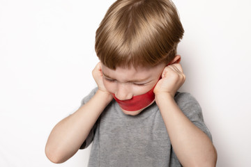 angry, frustrated, frightened boy with mouth sealed