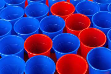 Beer pong, college party game. Plastic red and blue color cups