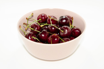 red cherries in a pink bowl