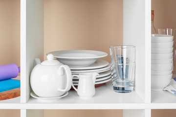 Fototapeta na wymiar Utensils and mugs, Kitchenware on wooden shelves