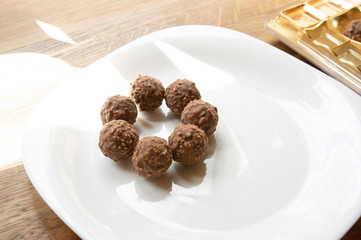round chocolate with nuts on a white plate