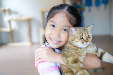 Cute girl hug and play scottish fold cat
