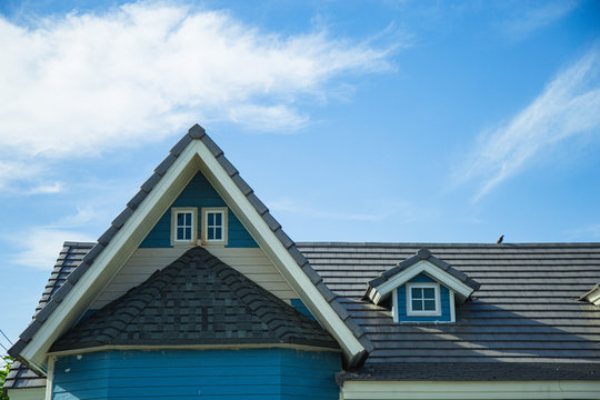 Close up blue American style modern gable and roof with sky background.