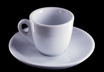 White porcelain cup and saucer for coffee, on a dark background, no body.