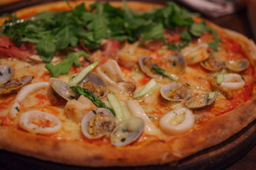Seafood pizza with shrimp, squid, clam and lettuce topping