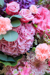 Pink and purple hydrangea, eucalyptus, pink roses, carnations and chrysanthemums.