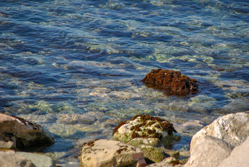 pebble beach with rocks in the water