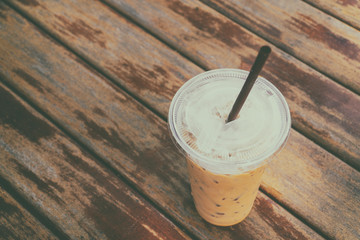 Ice coffee on old wooden table.
