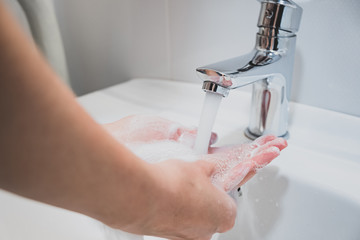 Washing hands with water in a sink. Cleaning hands, personal hygiene concept