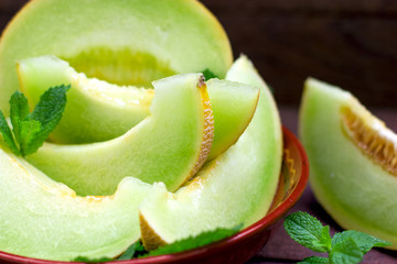 Melon slices in rustic bowl, slices of cantaloupe close-up 