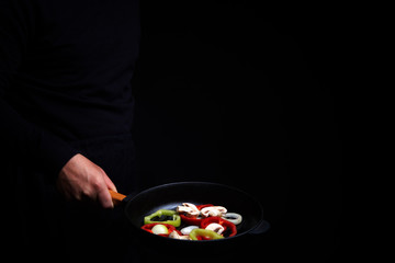 Professional chef. cooks vegetables in a pan, Asian cuisine. Eastern. A recipe book. Delicious healthy food