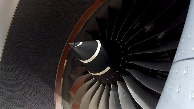 Closeup jet turbine engine of aircraft rotating 