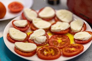 A plate of tomatoes with cheese