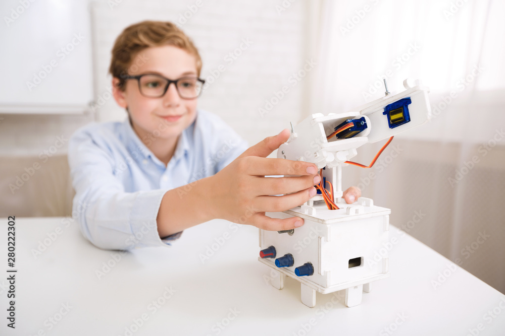 Aufkleber Smart boy testing his robotic device on engineering classes