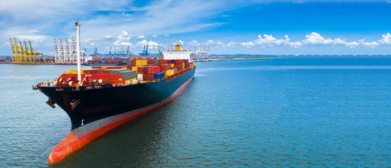 Aerial view container cargo ship carrying commercial container in import export business commerce logistic and transportation of international by container ship boat with copy space for banner web. - obrazy, fototapety, plakaty