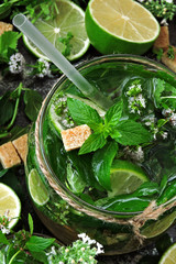 Homemade mojito drink with mint, lime and brown sugar. Healthy summer lemonade. Detox diet. Tonic drinks.