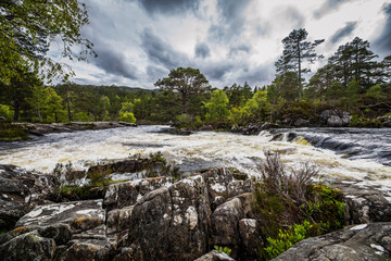 Picturesque landscape of a mountain river with traditional nature of Scotland.