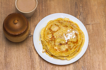 Sweet Homemade Pancakes with with powdered sugar and honey for Breakfast