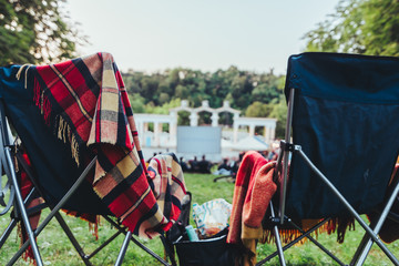 two folding chairs with cooling bag with beer and snacks in open air cinema