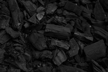 Black charcoal pieces texture background for barbeque - obrazy, fototapety, plakaty