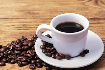 A cup of coffee and scattered coffee beans. Layout. Flat lay. Coffee bean.