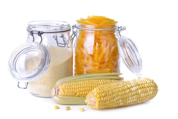 gluten free pasta and flour in  jars and fresh corn on white background