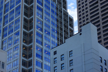 Fototapeta premium Metropolis modern buildings architecture background. Different style skyscrapers and reflections close up. Architecture style of Minneapolis, Minnesota, USA. Urban city architecture.