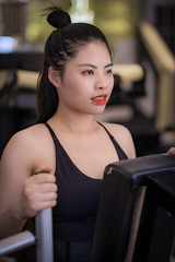 A Chinese young lady has weights training indoors.
